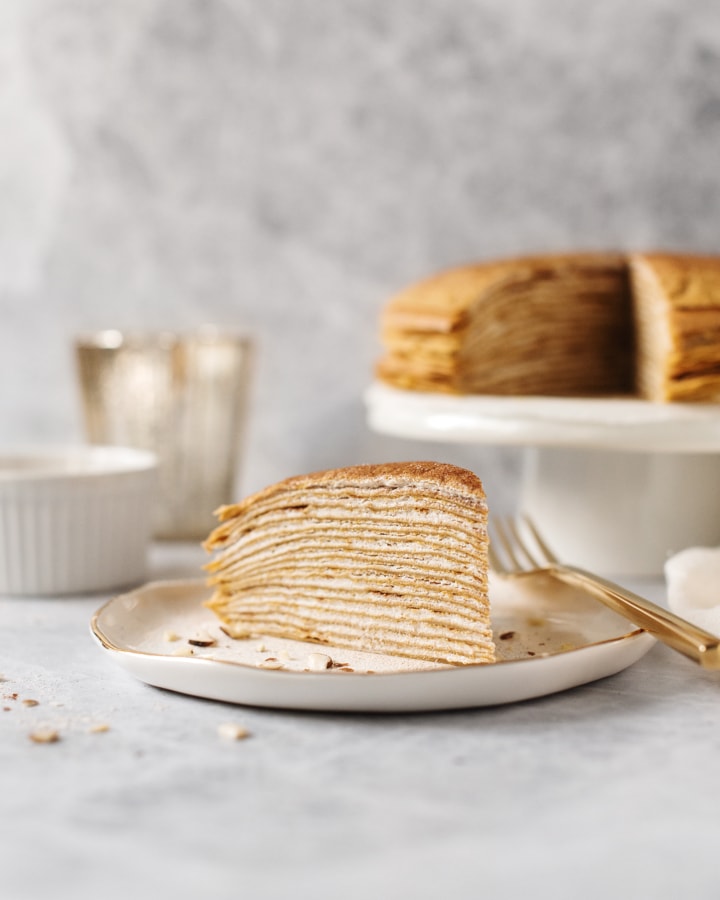 Side shot of all the layers of a slice of pumpkin crepe cake
