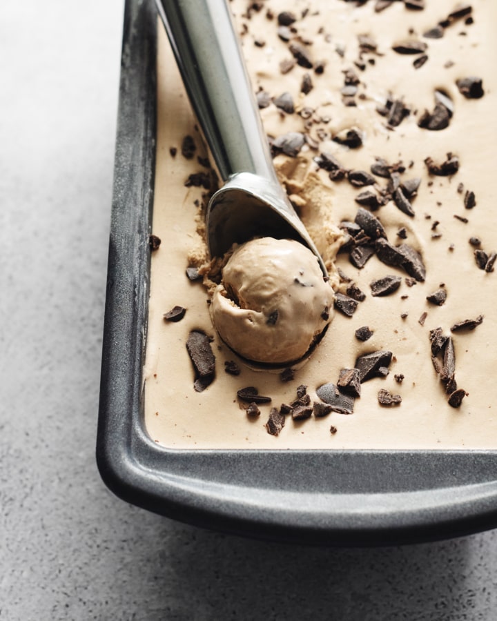 Ice cream scooper in a pint of coffee chocolate chunk ice cream