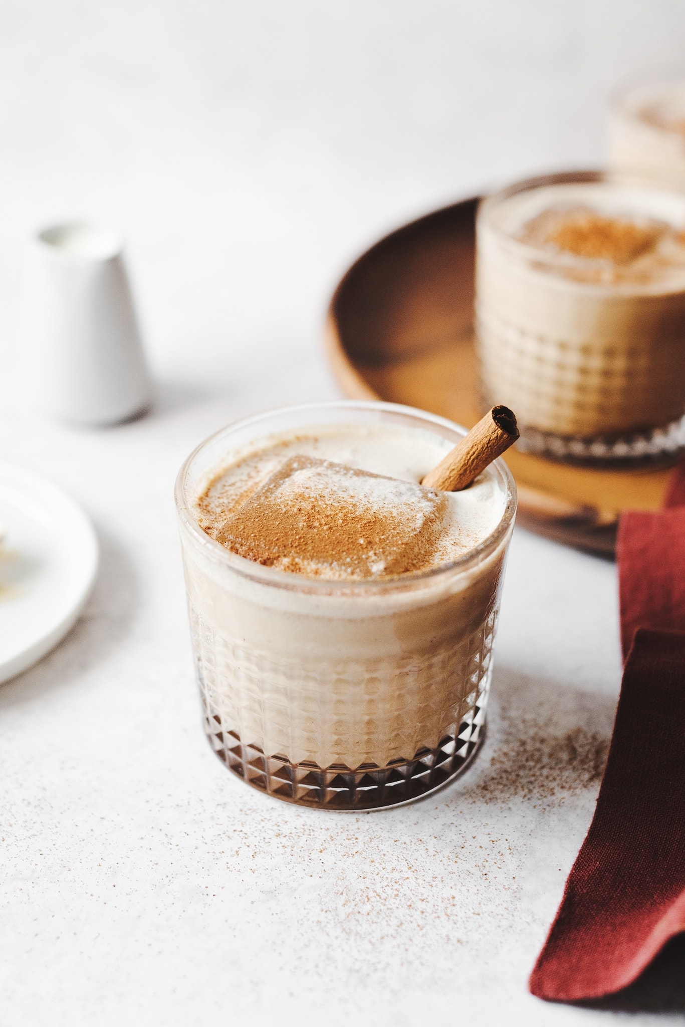 Pumpkin spice white russian cocktail in a glasses with cinnamon stick