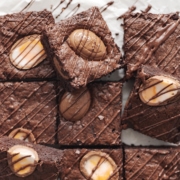 Squares of creme egg brownies with chocolate drizzle
