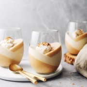 Pumpkin panna cotta topped with whipped cream in a glass