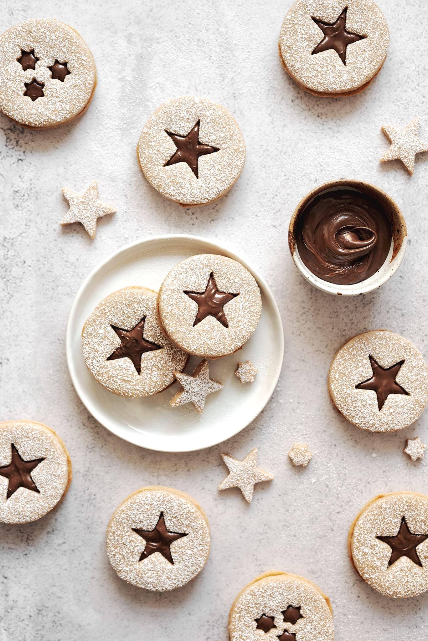 Hazelnut linzer cookies with star cut outs on table
