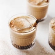 Close up of pumpkin spice white russian cocktails and large ice cubes