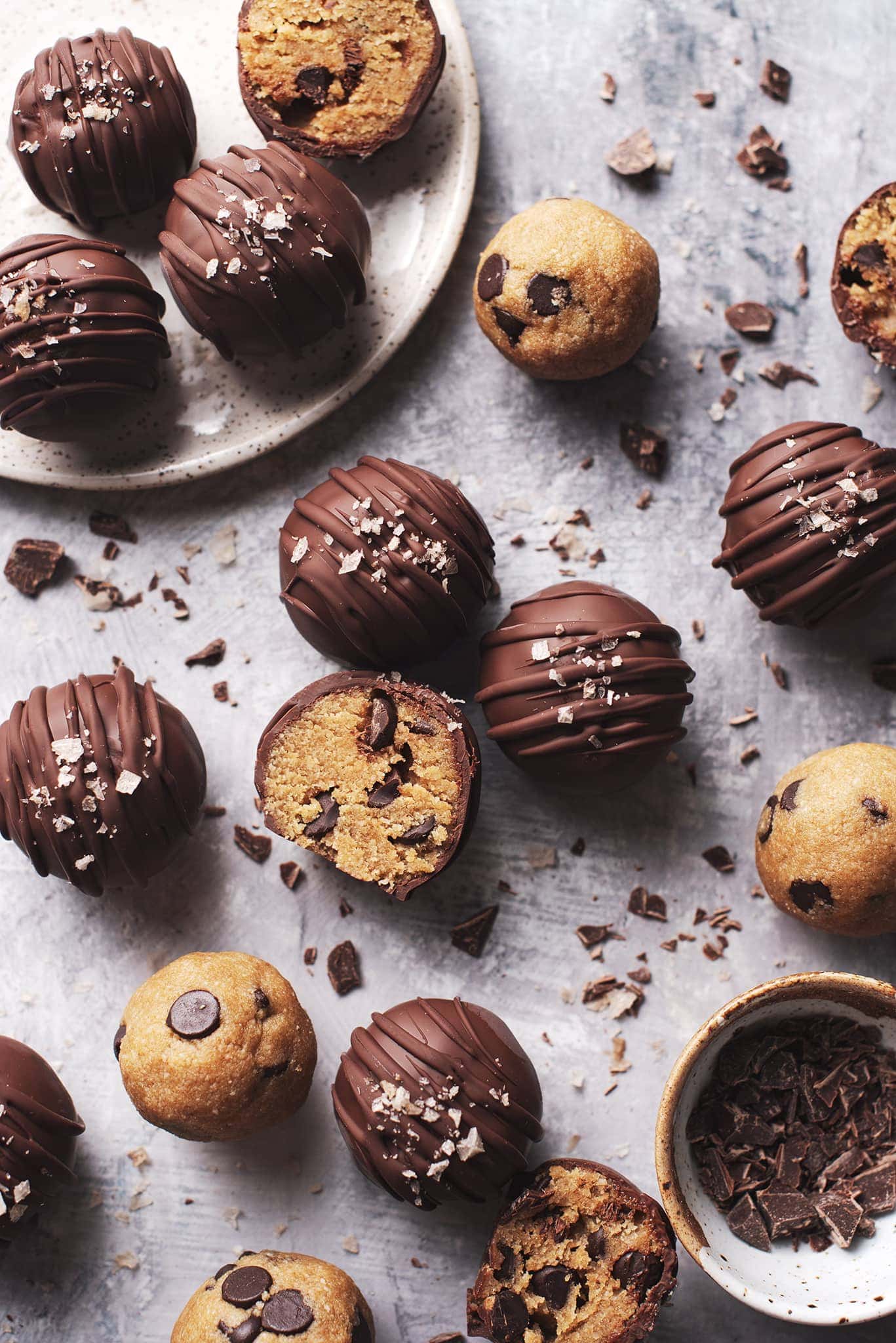 chocolate chip cookie dough bites scattered on grey surface
