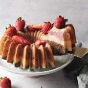 Lifting a slice of neapolitan bundt cake to show layers