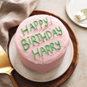 Pink cake with ‘Happy Birthday Harry’ written in green icing