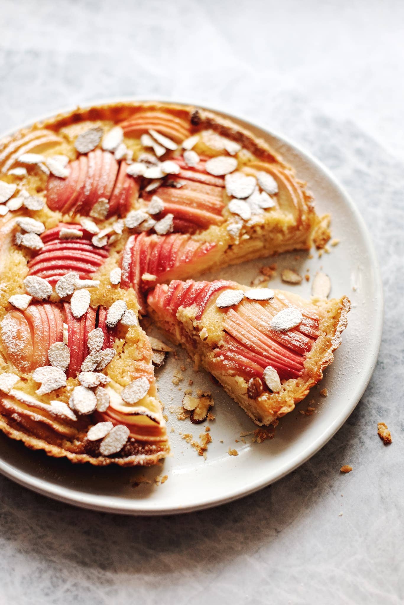 apple and frangipane tart with a slice cut out of it