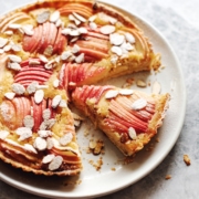 apple and frangipane tart with a slice cut out of it