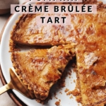pumpkin crème brûlée tart with a slice cut out of it