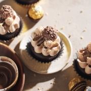 ferrero rocher cupcake on plate topped with chocolate buttercream