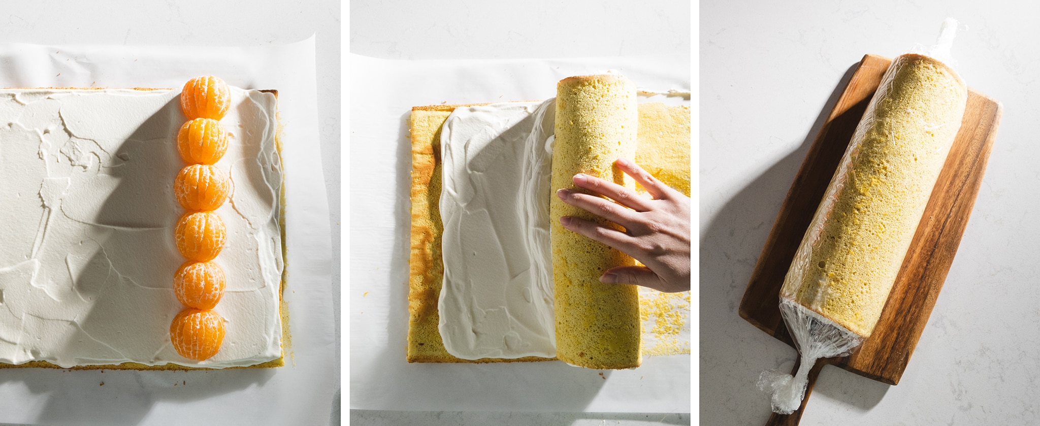 rolling up orange sponge cake into a swiss roll