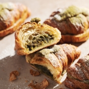 matcha almond croissant cut in half to show filling