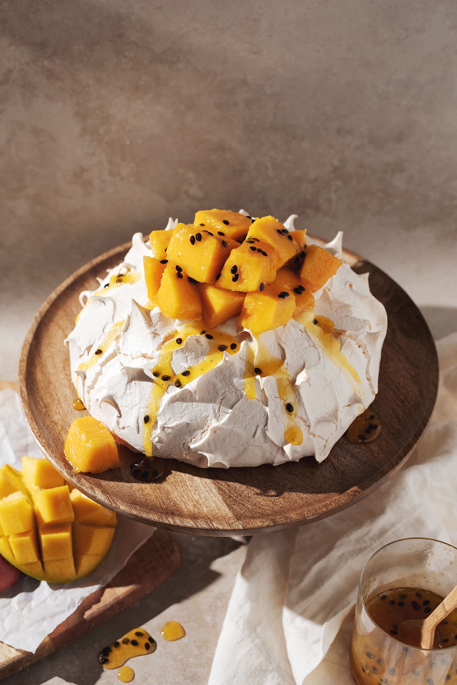 pavlova topped with mango chunks and passionfruit puree