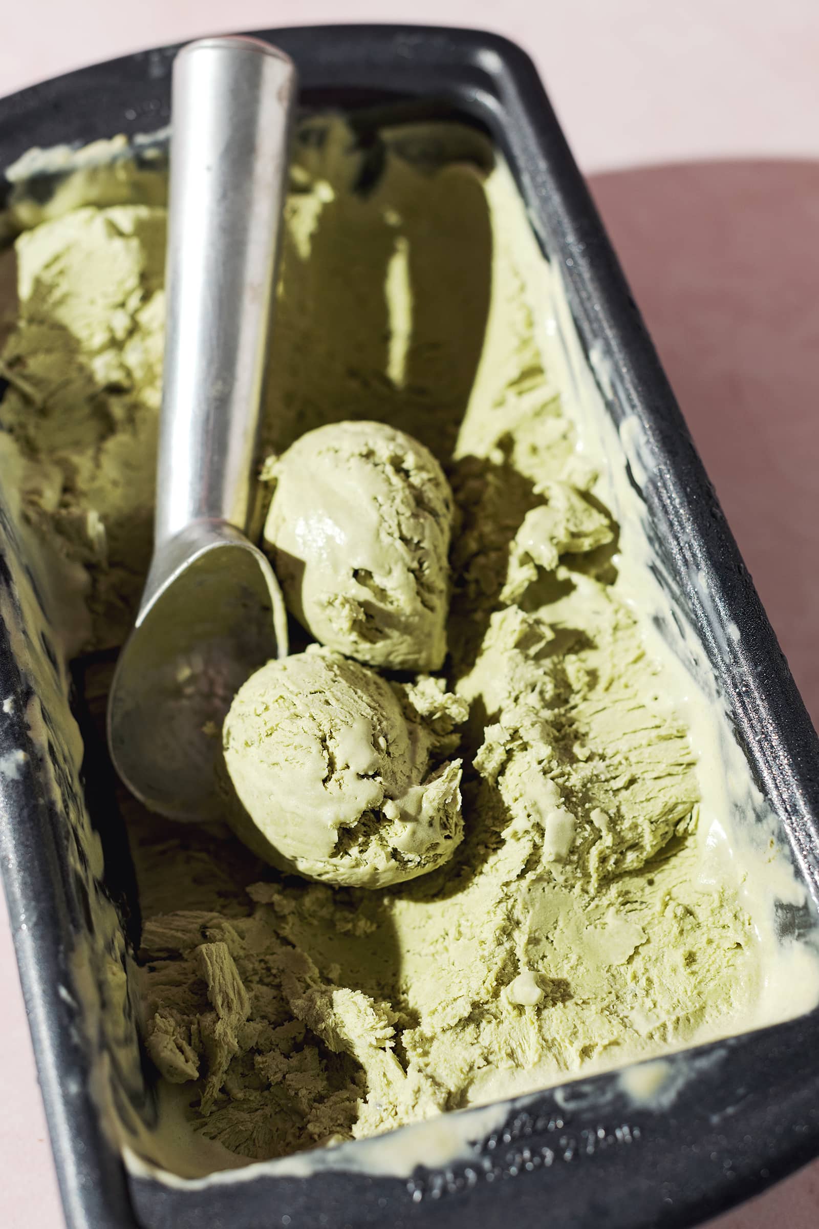 scoops of matcha ice cream in a tin