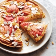 Apple and frangipane tart with a slice cut out of it