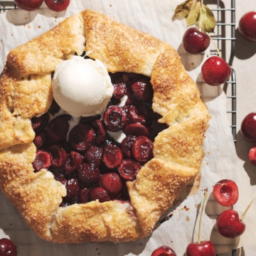 Cherry galette with a scoop of vanilla ice cream on top.