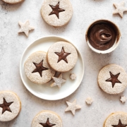 Hazelnut linzer cookies with star cut outs on table