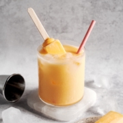 Mango melona soju cocktail with melona popsicle sticking out