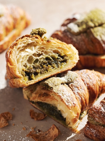 Matcha almond croissant cut in half to show filling