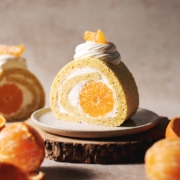 slice of orange swiss roll with mandarin orange in the middle