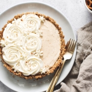 Peanut butter ice cream pie with whipped cream rosettes and brown linen