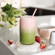 Strawberry matcha latte with green and pink layers in a glass