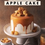 Caramel apple cake with caramel drips on cake stand.