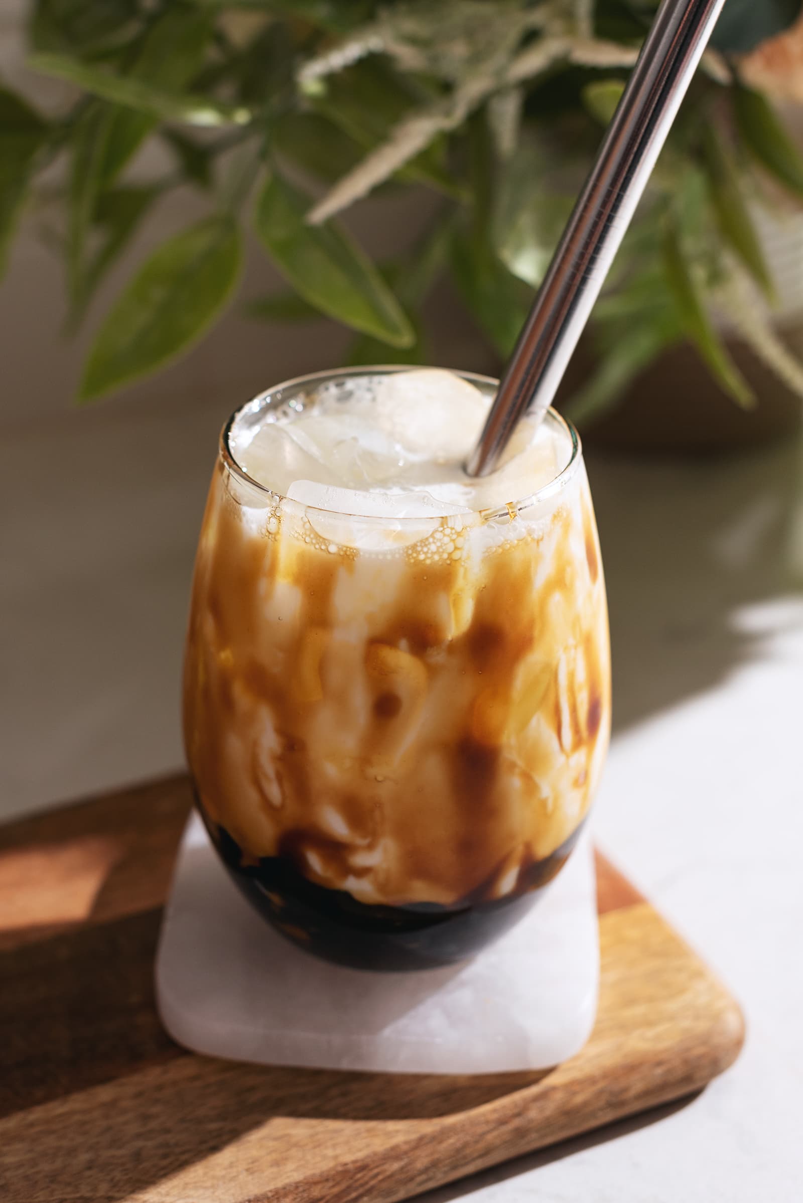 Glass drizzled with brown sugar syrup and filled with milk and boba.