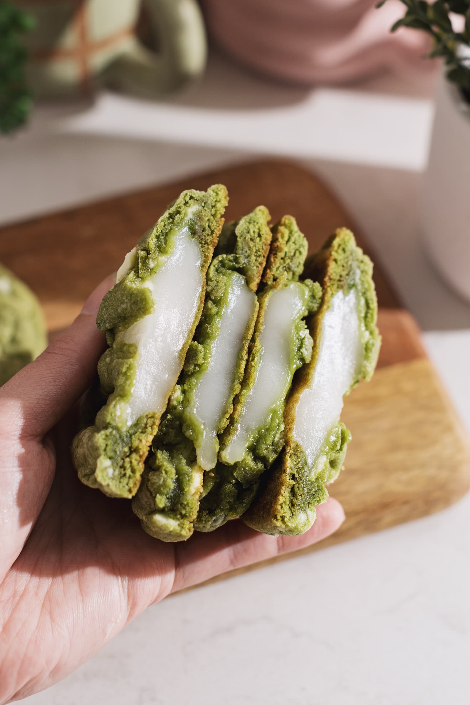 Cross section of matcha cookies cut in half to show the mochi inside.