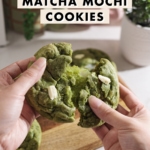 Pulling a matcha mochi cookie apart to show the stretchy mochi inside.
