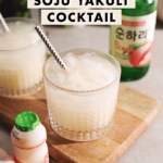 Milky white soju yakult cocktail in a highball glass.