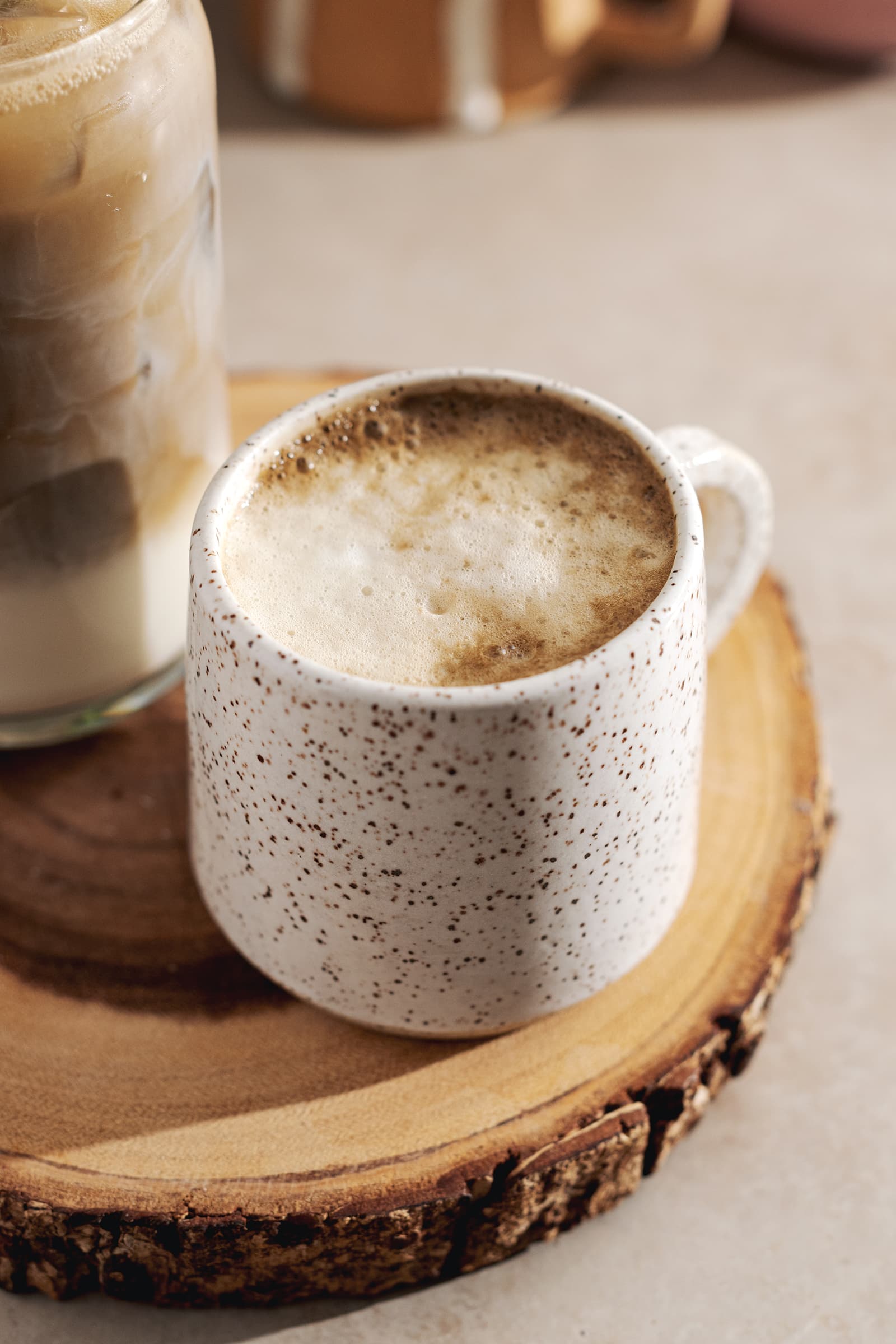 Speckled mug filled with a latte with frothy milk.