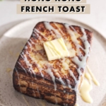 Hong Kong french toast on a plate with a square of butter on top and drizzled with condensed milk.