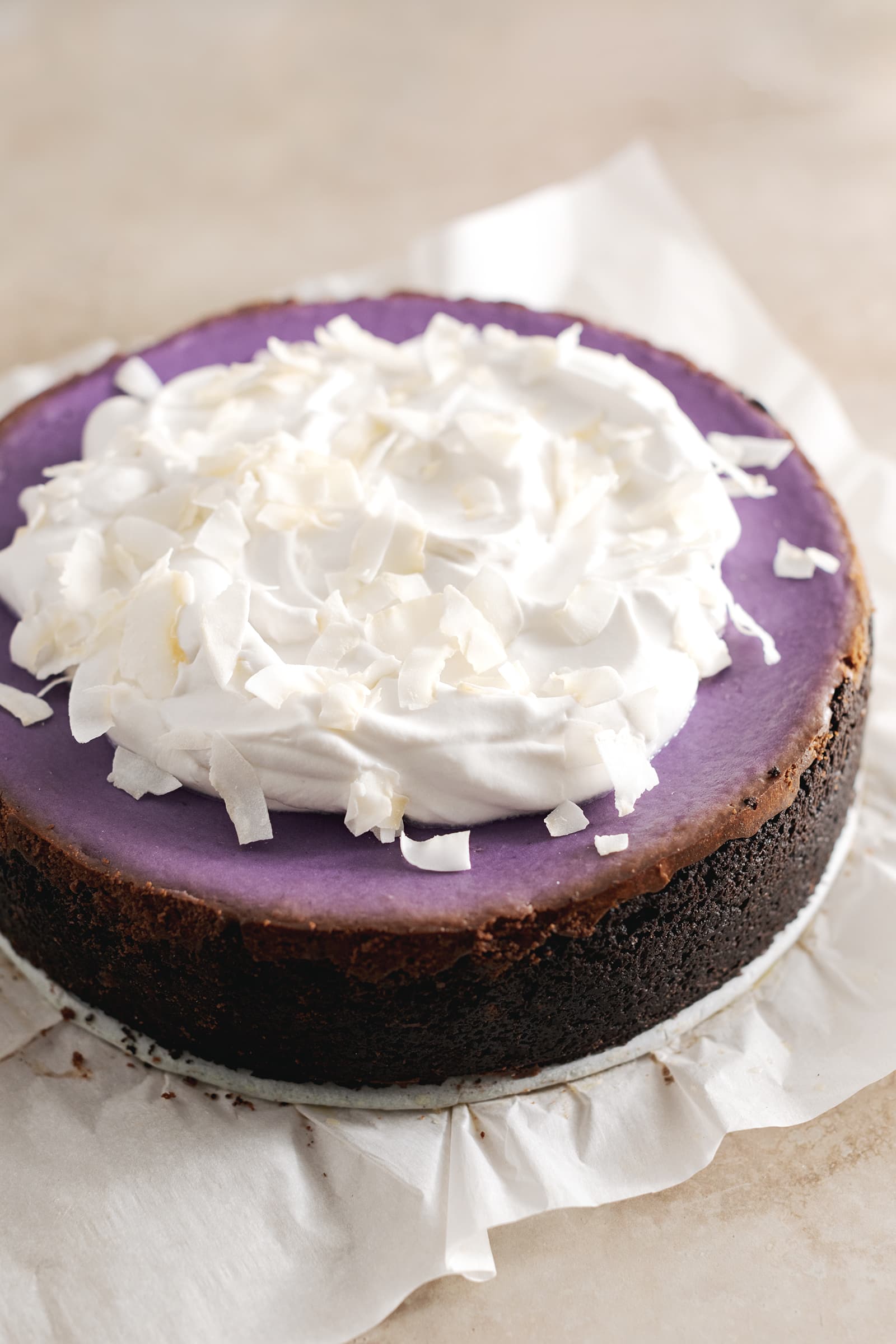 Purple yam cheesecake with dollops of coconut cream spread on top.