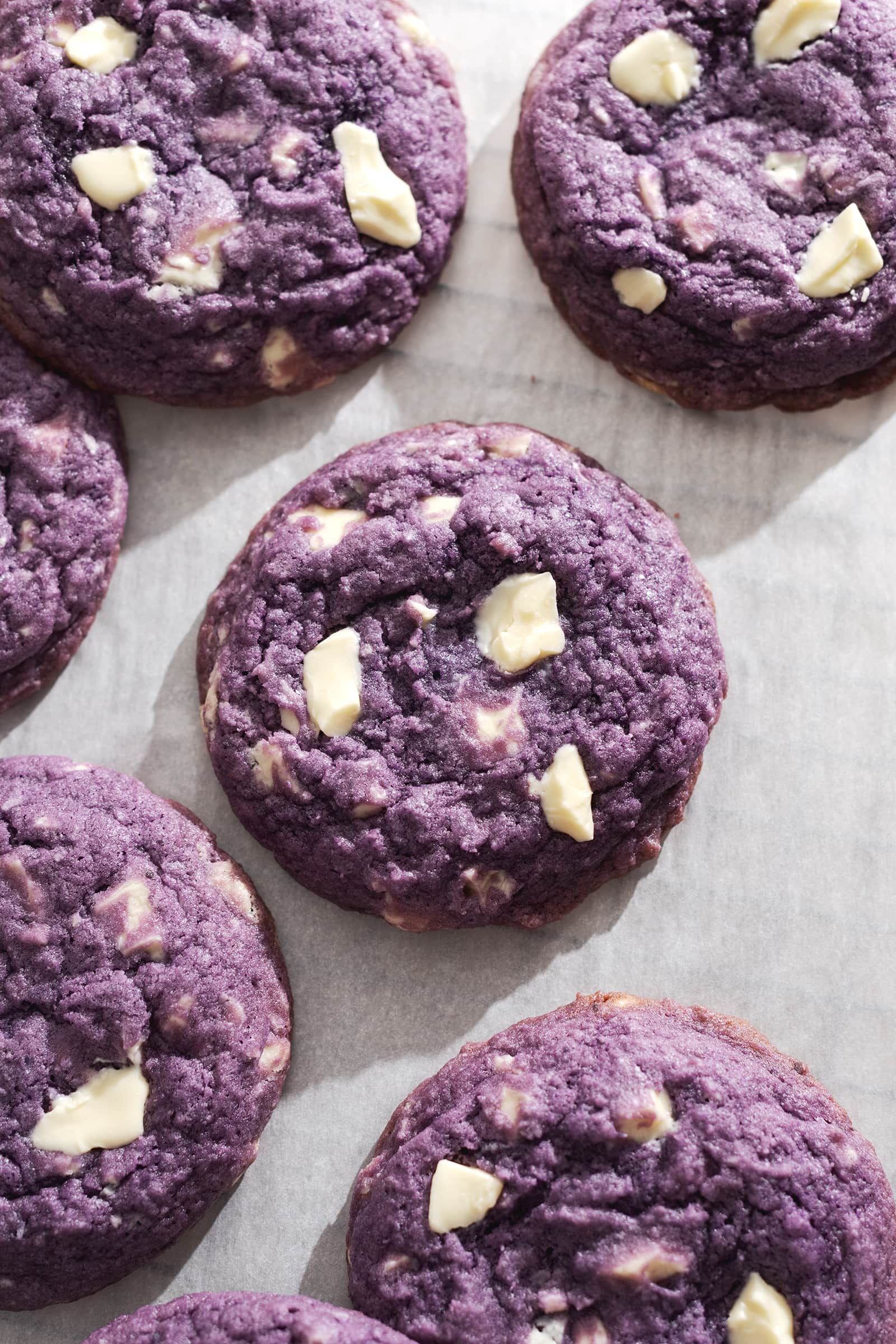 Purple cookie with white chocolate chunks surrounded by more ube cookies.