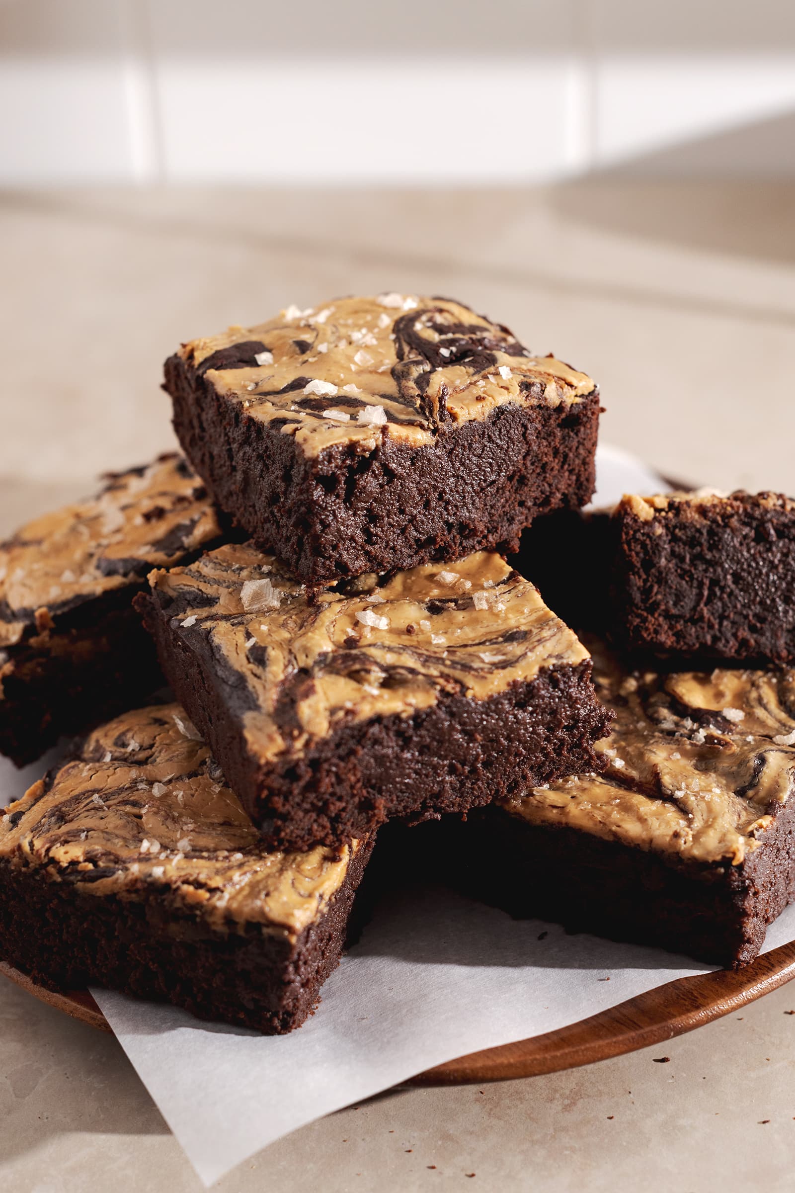 A stack of banana peanut butter brownies piled on a plate.