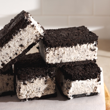 Oreo ice cream sandwiches stacked on top of each other.