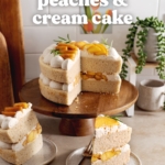 Two slices of peaches and cream cake on plates with the rest of the cake on a wooden cake stand behind them.