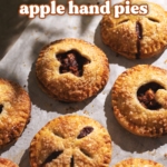 Apple hand pies scattered on parchment paper.
