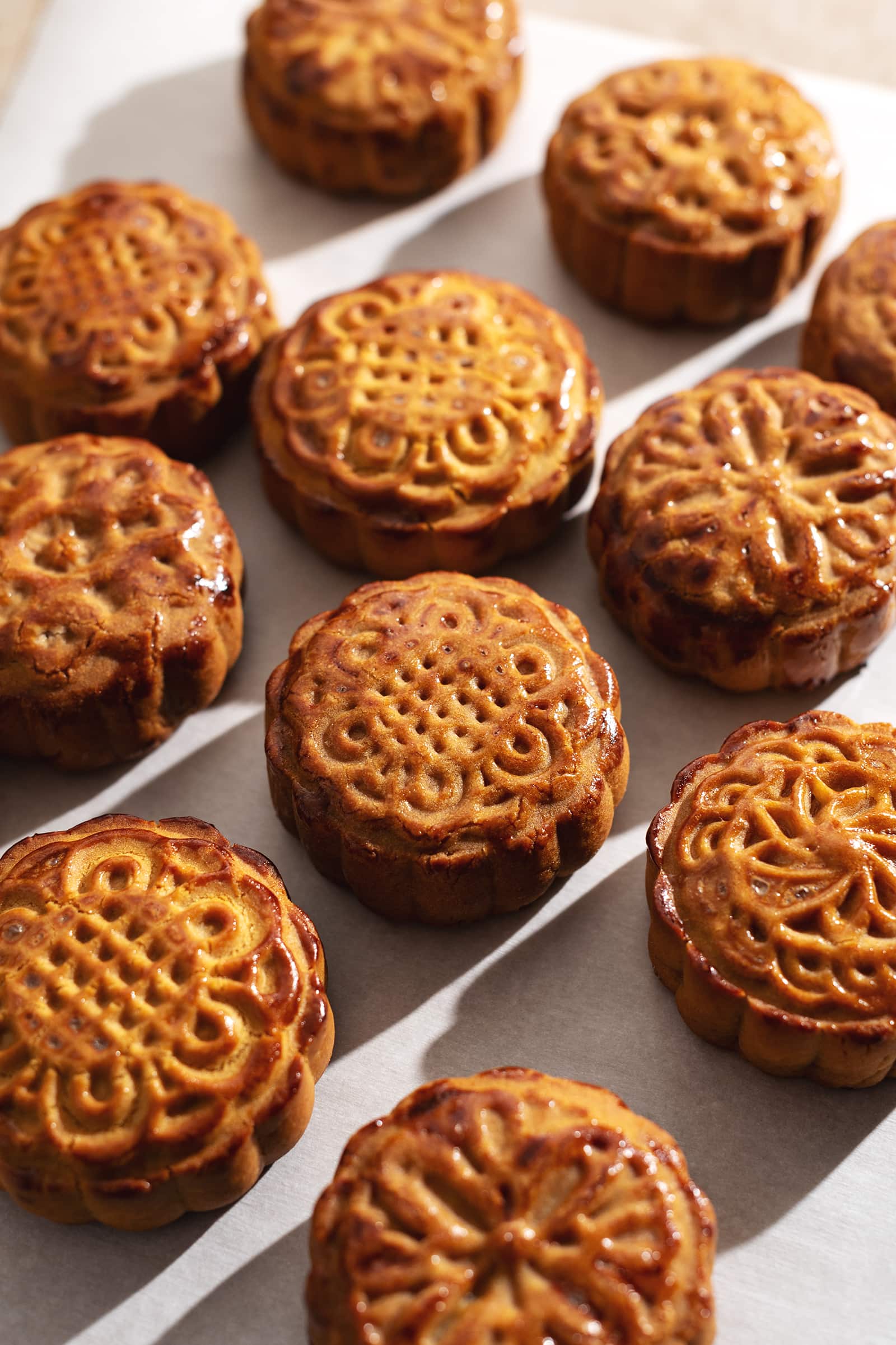 Several baked mooncakes scattered on counter.