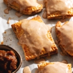 Pumpkin pop tarts with icing dripping down the sides.