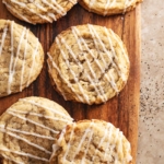Earl grey sugar cookies scattered on a wooden board.