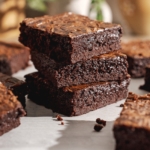 A stack of three miso brownies surrounded by more brownies.
