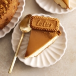 Slices of biscoff cheesecake on scalloped plates.