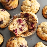 A banana blackberry oatmeal muffin cut in half to show the texture inside.