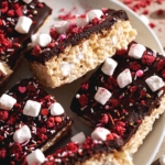 A Valentine's Day rice krispie treat leaning on its side to show the layers of chocolate ganache and rice krispies.