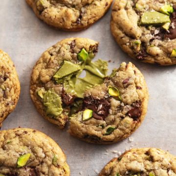 A pistachio cream cookie split in half to show the pistachio cream inside.