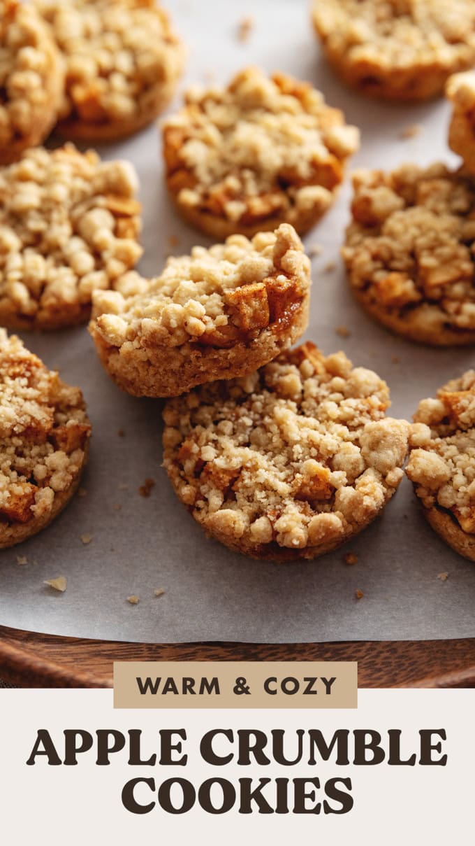 An apple crumble cookie resting on another cookie to show the apple filling inside.