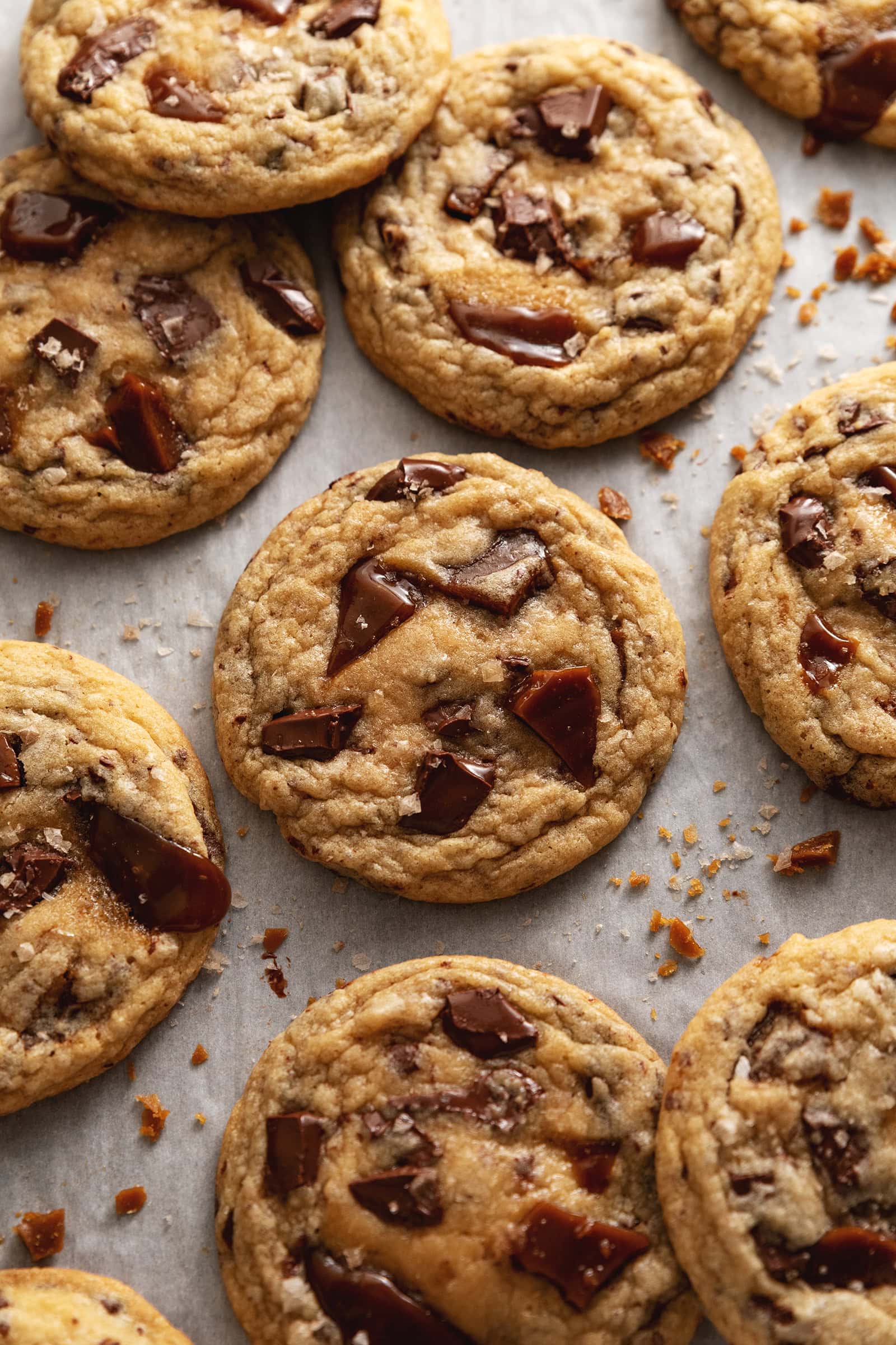 Toffee cookies scattered on parchment paper.
