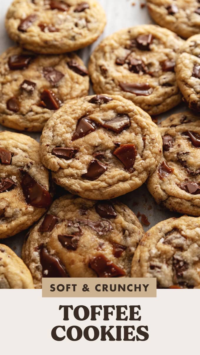 Several toffee cookies slightly overlapping on parchment paper.